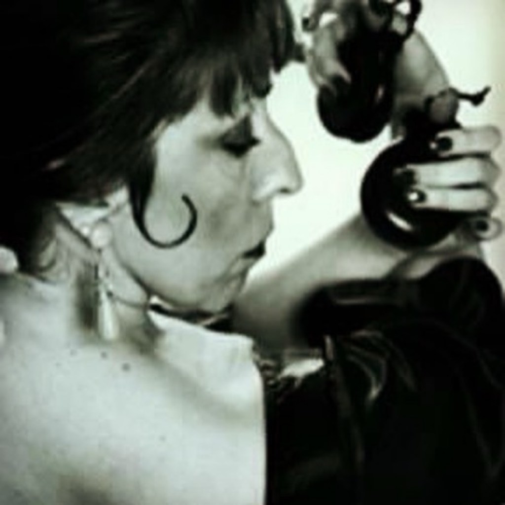 Carolina Lugo playing castanets, black-and-white profile