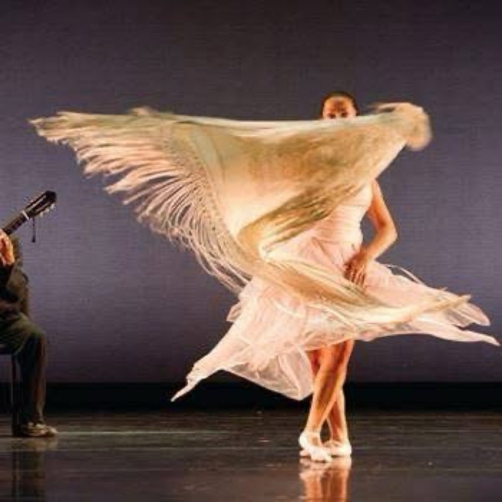 CarOlé Flamenco dancing with a white mantón on stage